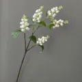 Close-up detail of artificial white berry branch, featuring foam berries and green leaves. - Off White