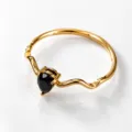 Detailed view of the gold wavy ring featuring a black pear-shaped zirconia stone. - Gold Style 10