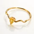 Detailed shot of the minimalist wavy gold stainless steel ring featuring a pear-shaped stone. - Gold Style 9