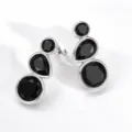 Detailed close-up of geometric silver-tone earrings featuring elegant black stone drop accents. - Silver Style 3