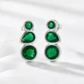 Detailed view of elegant silver earrings featuring three vertical green simulated gemstones. - Silver Style 2