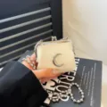 Mini white kiss-lock crossbody bag with silver crescent moon and ball chain strap chic style. - Crescent Moon / White