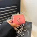 Mini pink kiss-lock shoulder bag featuring cute moon hardware and stylish silver chain strap. - Crescent Moon / Pink