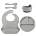 Grey silicone baby feeding set with divided plate, bowl, bib, spoon, and fork for infants. - Silicone Fork And Spoon 5-Piece Set / Smoke