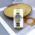 Women's gold quartz watch with round sunburst dial, arabic numerals, and stylish steel strap. - Black