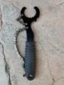 Detail view of the bicycle cassette lockring tool chain whip, showing metal links and handle. - Black and White