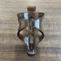 Detailed view of brown translucent plastic bicycle bottle cage, durable cycling accessory. - One Size / Thickened Widened Coffee