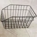 Black metal bicycle rear wire basket detail view, durable mesh storage basket for mountain bikes. - Solid Style
