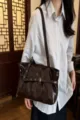 Women brown patent leather shoulder bag, stylish motorcycle style tote with buckle details. - Coffee
