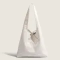 White soft leather hobo shoulder bag detail showing elegant bow tie and vertical seam design. - White