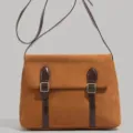 Detailed view of the brown vintage suede messenger bag with stylish dual buckle straps. - Brown