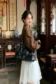 Black leather shoulder bag for women, niche design motorcycle style tote bag with metal eyelets. - Black