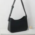 Classic black underarm shoulder bag for women, versatile minimalist hobo handbag style. - Black