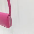Detailed close-up view of the pink mini crossbody bag highlighting its zipper and side leather texture. - Rose Red