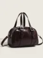 Detailed view of the dark brown retro pillow bag, showing the metal buckle and texture. - Dark Coffee