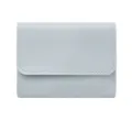 Light blue trifold wallet detail, compact card holder with fine stitching and smooth finish. - Light Blue