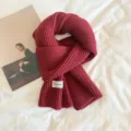 Wine red knitted scarf detail, cozy ribbed winter neck warmer with stylish label. - Burgundy