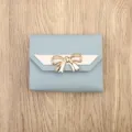 Light blue three-fold short wallet for women with cute metal bow and pink accent strap. - Blue