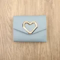 Light blue short wallet with gold heart accent, trifold card holder for women style. - Blue