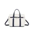 Detailed view of small contrast canvas handbag, top handle, adjustable strap, casual style. - White and Blue