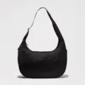 Black nylon crossbody dumpling bag with adjustable strap, large capacity casual shoulder bag. - Black