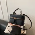 Black leather cosmetic box bag with top handle and gold zipper hardware style. - Black PU Leather