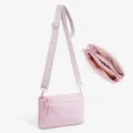 Detailed view of the pink multi-compartment crossbody bag showing interior and strap. - Pink