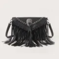 Black leather crossbody bag featuring metal fringe studs and a striking skull ornament detail. - Black Large