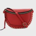 Stylish red crescent sling bag featuring gold-tone studs and adjustable strap for women. - Red