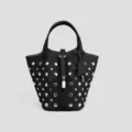 Black leather bucket bag featuring metallic silver studs, top handle, and padlock charm style. - Black