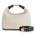 Woven straw handbag detail showing premium texture, black leather handles and gold metal hardware. - Black