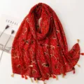 Detail view of the red printed cotton linen scarf with tassel details, vintage floral pattern. - Red Series 16