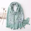 Detailed close-up of the light green bohemian cotton linen floral print scarf with cute tassel hem. - Fresh Series 17
