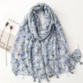 Floral print tassel scarf detail showing soft cotton linen texture and delicate flower pattern. - Fresh Series 18