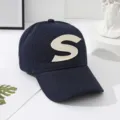 Classic navy blue baseball cap for men and women featuring a bold beige letter S patch. - Navy Blue