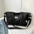 Black large capacity travel duffel bag tote handbag with shoulder strap and cute monkey pendant. - Black With Pendant