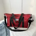 Large capacity nylon duffel bag travel tote shoulder bag with stylish straps and monkey charm. - Red With Pendant