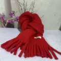 Detail shot of the soft plush red winter scarf showcasing cozy fringe and fine knit texture. - Burgundy Soft Plush Scarf