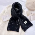 Cozy black knit winter scarf with white texture pattern and stylish label design for women. - Black