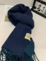 Detailed shot of dark blue cashmere-feel winter scarf with classic fringe and branded tag. - Double-Sided Royal Blue