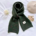 Detailed shot of the dark green knitted winter scarf with soft texture and cozy warmth. - Dark Green