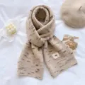 Close-up detail of cozy beige knit winter scarf featuring soft texture and stylish speckled pattern. - Beige