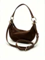 Brown suede crescent shoulder bag detail view, showing soft matte texture and metallic rings. - S / Coffee Suede