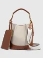 Detail view of the stylish canvas bucket bag with wide strap, brown leather trim, and small pouch. - S / Off White