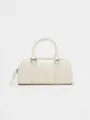 Detail view of the cream white retro boston handbag featuring stylish metal hardware and handles. - S / White