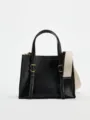 Black leather mini handbag detail featuring contrast white stitching and wide strap. - S / Black