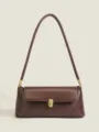 Detail view of the elegant brown leather underarm shoulder bag with golden metal hardware. - Brown (PU)