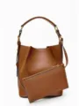 Detailed view of brown leather bucket bag featuring elegant contrast stitching and hardware. - S / Tan