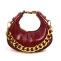 Chic burgundy oil-wax leather mini hobo handbag with bold gold chain and metal buckle. - Red