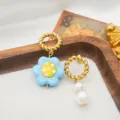 Korean niche glazed flower stainless steel asymmetric pearl detail earrings showcasing exquisite style. - Blue
